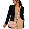 vyntera-blush-model-cutout-v1 Model wearing the blush textured sling bag with patterned strap